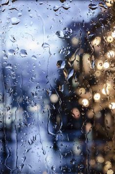 rain drops on the window with buildings in the background