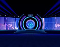 an empty stage is lit up with blue lights and the words'thinking about nature'on it