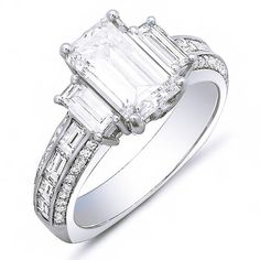 Declare your love and commitment to her with this astounding 2.90 Ct. diamond engagement ring. It has a GIA certified 1.70 Ct. Emerald cut center diamond with I color grade and VS2 clarity. On each side of the center stone are Baguette cut diamonds while additional Baguette and Round cut diamonds line the shank in channel and micro pave set, respectively. Custom made matching band can be ordered upon request! Metal : Available in 14K Gold, 18K Gold or Platinum Setting Type : Channel, Pave, Prong Ring Types, 3 Stone Diamond Ring, Baguette Engagement Ring, Emerald Cut Diamond Engagement Ring, Emerald Cut Diamond Engagement, Emerald Cut Diamond Ring, Emerald Cut Engagement, 3 Stone Engagement Rings, Emerald Engagement Ring Cut