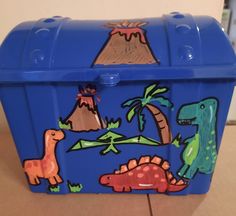 a blue box with dinosaurs painted on it