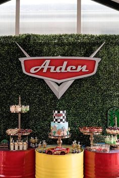 an assortment of desserts on display in front of a sign