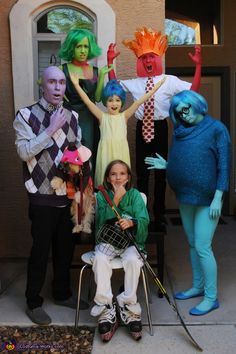 a group of people in costumes posing for a photo