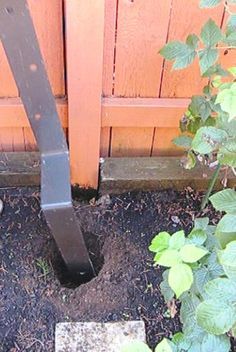 a cement block sitting in front of a wooden door next to a green planter