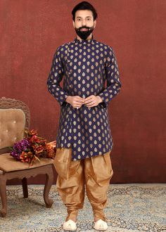 Look dapper wearing this readymade navy blue sherwani made in jacquard silk enhanced with fine woven motifs all over. Crafted with a mandarin collar with buttoned up front, asymmetric pattern and full sleeves. Accompanied by a dupion silk dhoti pants in beige color.  Do Note: All Accessories shown are for styling purpose only. Buttons are a part of adornment and it can vary in design. Slight color variation may occur due to photographic reasons. Measurement variation up to 1 inch is possible. Indo Western Saree, Modern Groom, Cyan Colour, Gown With Dupatta, Sea Green Color, Dhoti Pants, Navy Blue Fabric