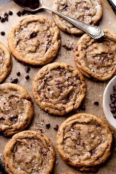 chocolate chip cookies on a baking sheet with spoon