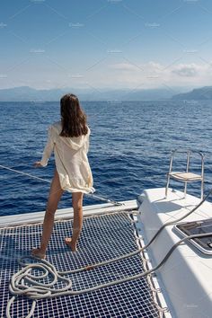 a woman standing on the deck of a boat