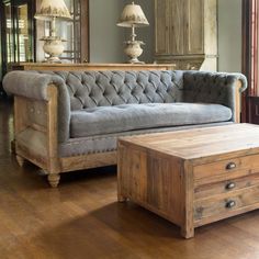 a living room with a couch, coffee table and mirror