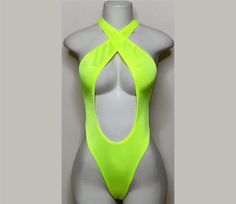 Welcome to my shop Let's Make Money Together 💕 DETAILS  * Handmade Item  * Materials: Nylon, Spandex * Crossover Bodysuit  * Never used  DESCRIPTION  * Thong Bodysuit  * Neon Yellow Spandex * 4 way stretch Fabric  * Mannequin is wearing  XS/Small (may choose sizing at checkout) SHIPPING  My current shipping turnaround is really quick 1 to 2 days  RETURNS & EXCHANGES  No refunds or exchanges  Please ask all questions before ordering with my shop if you are unsure of sizing options. If you have a Fabric Mannequin, Club Attire, 4 Way Stretch Fabric, Rave Outfits, Womens Bodysuit, Catsuit, Neon Yellow, Dance Wear, Crossover