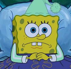 spongebob is sitting in bed wearing a party hat