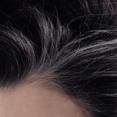 a close up view of someone's gray hair