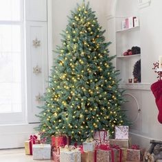 a christmas tree with lights and presents under it