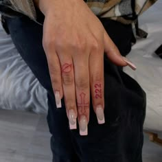 a woman's hand with a pink manicure on her left thumb and the word love written in red ink