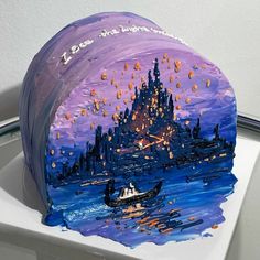 a toilet seat with a painting on it's lid in the shape of a castle