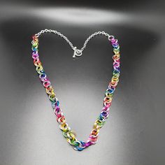 23 Inch rainbow pride necklace  Handcrafted chainmaille  Multicolor and silvertone  Silverplated Toggle Clasp  Pride lightweight gift party celebration fun Unisex Pride Month Free shipping  Warranty against damage and defects for 1 year after date of purchase  Buyer pays return shipping  55-018 Rainbow Metal Jewelry With Adjustable Chain, Rainbow Chain Necklace As Gift, Rainbow Chain Necklace For Gift, Rainbow Metal Jewelry For Jewelry Making, Multicolor Metal Chain Necklace For Gifts, Multicolor Metal Chain Necklace As A Gift, Handmade Jewelry For Pride Gift, Multicolor Jewelry For Pride Gift, Pride Multicolor Jewelry Gift