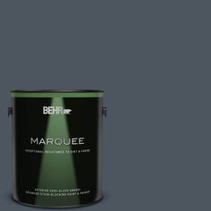 the behr marquee paint is shown in dark gray, and it has a green