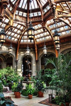 the inside of a large building with lots of plants