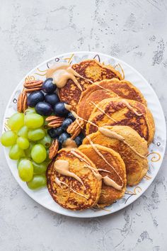 pancakes, grapes and pecans on a plate