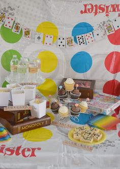 a table topped with lots of cakes and cupcakes