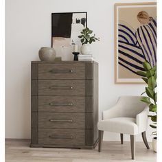 a white chair sitting next to a tall wooden dresser