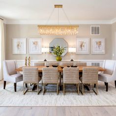 a dining room table with six chairs and a chandelier