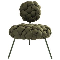 an upholstered chair with metal legs and a knoted cushion on the back