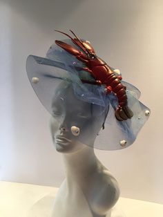 Sea food Festival- Lobster Festival - Lobster Hat- Beach Headpiece- Wedding - Shell headband- Beach headpiece- Mermaid costume Hello, This fascinator can be worn at a beach wedding, birthday, Derby ,or for a mermaid costume. It's made with a plastic Lobster and real shells. It is 2 inches high and diameter is 10 inches wide. One of a kind...each one is a little different. Netting (with tiny shells all over it) a is shown in blue like water but can be in other colors....just ask. It's lobster is Spring Beach Fascinator, Summer Beach Fascinator, Elegant Beach Fascinator, Octopus Fascinator, Lobster Mermaid, Lobster Festival, Shell Headband, Tiny Shells, Mermaid Costume