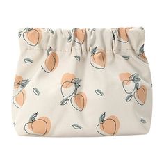 a white bag with oranges on it and a zippered pouch hanging from the side