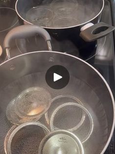 pots and pans sitting on top of a stove with water in them next to each other