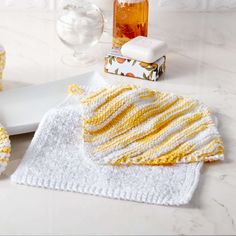 a white tray topped with yellow and white towels