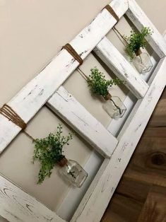 an old window is decorated with plants and mason jars