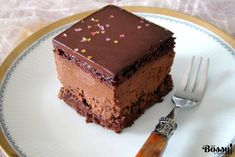 a piece of chocolate cake sitting on top of a white plate