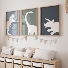 three dinosaur silhouettes are hanging on the wall above a bench with storage bins