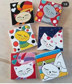 four square coasters with cats painted on them