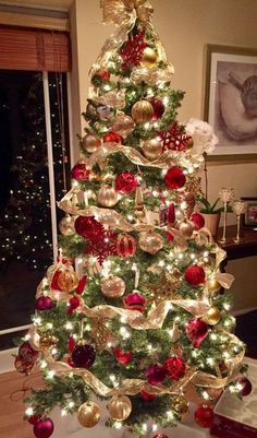 a christmas tree decorated with red and gold ornaments