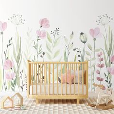 a baby's room with flowers painted on the wall