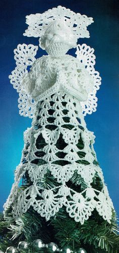 a crocheted christmas tree with an angel on top