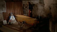 a doll sitting on top of a table next to a wooden box and other items