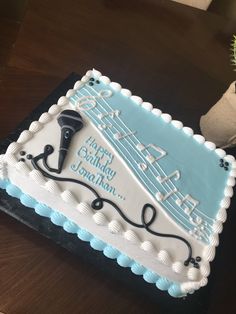 a birthday cake with a hair dryer on it's side sitting on a table