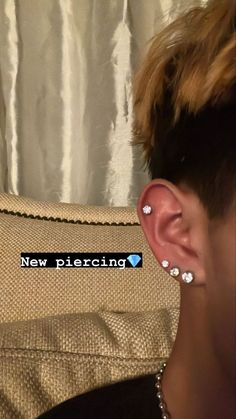 a person with ear piercings on their ears and the words new piercing above them