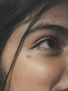 a close up of a woman's face with dark hair