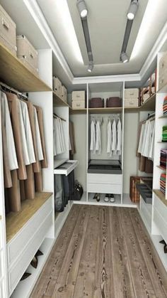 a walk in closet filled with lots of white drawers and shelves next to a wooden floor