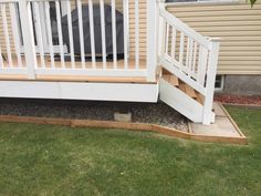 a white porch with steps leading up to it