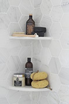 two shelves in a bathroom filled with personal care items