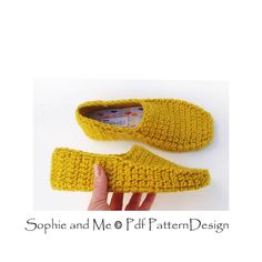 a pair of crocheted slippers is shown in yellow