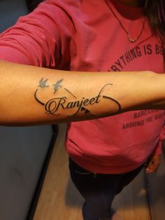 a woman with a name tattoo on her arm