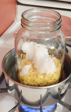 a glass jar filled with rice sitting on top of a stove