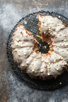 a glazed donut with white sprinkles on a cooling rack