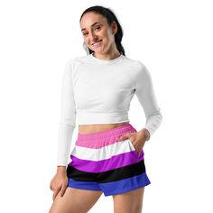 a young woman wearing shorts and a white top with purple, black, and blue stripes