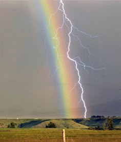 a rainbow appears to be in the sky with a lightning bolt coming from behind it