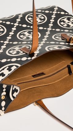 CalfskinEmbossed logoOpen topZip and patch interior pocketsAdjustable handlesSuede backingWeight: 37oz / 1.05kgImported, CambodiaStyle #TORYB50540 T Monogram, Tory Burch Tote, Tory Burch Bag Totes, Monogram Tote Bags, Monogram Tote, Tory Burch Bag, Black Tote, Small Tote, Monogram Logo